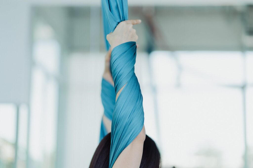 close up shot of a person holding an aerial silk